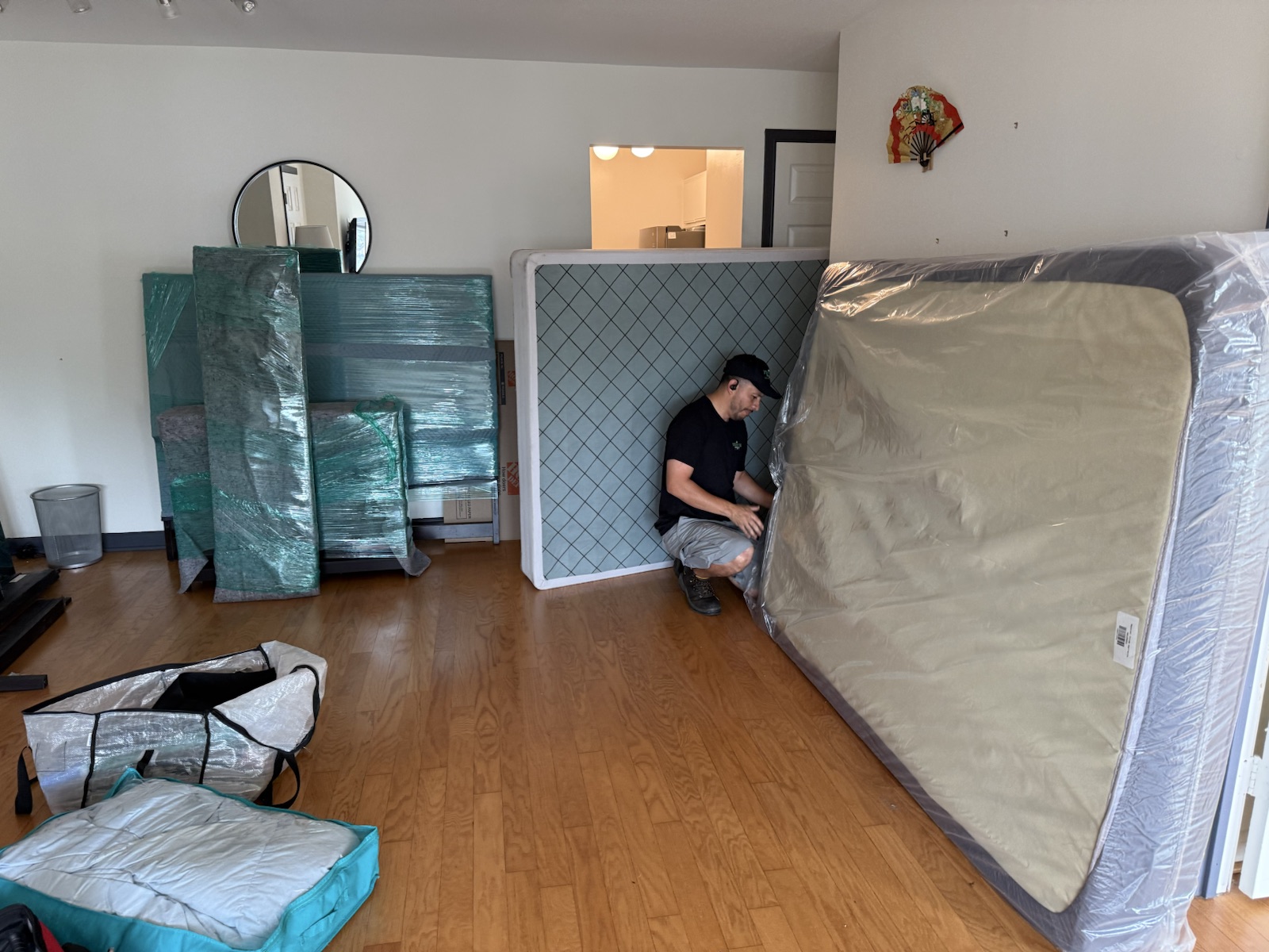 NewPath crew wrapping and moving mattresses inside a home